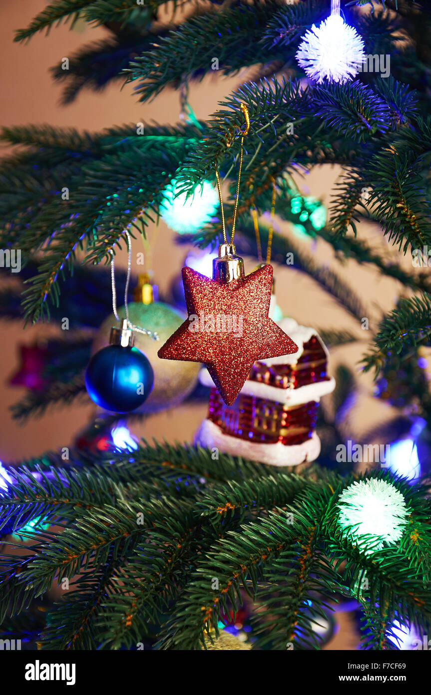 House, balls, stars and lighting garland on the Christmas tree Stock Photo