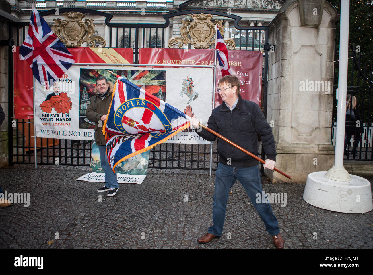 Belfast, UK. 28th November, 2015. Willie Frazer  (R)  Holding Loyal People Protest flag at the 3rd Anniversary decision of  Belfast City Council to restrict the flying of the union flag to 18 days per year. Mr Frazer is the founder and leader of the pressure group Families Acting for Innocent Relatives (FAIR). Credit:  Bonzo/Alamy Live News Stock Photo