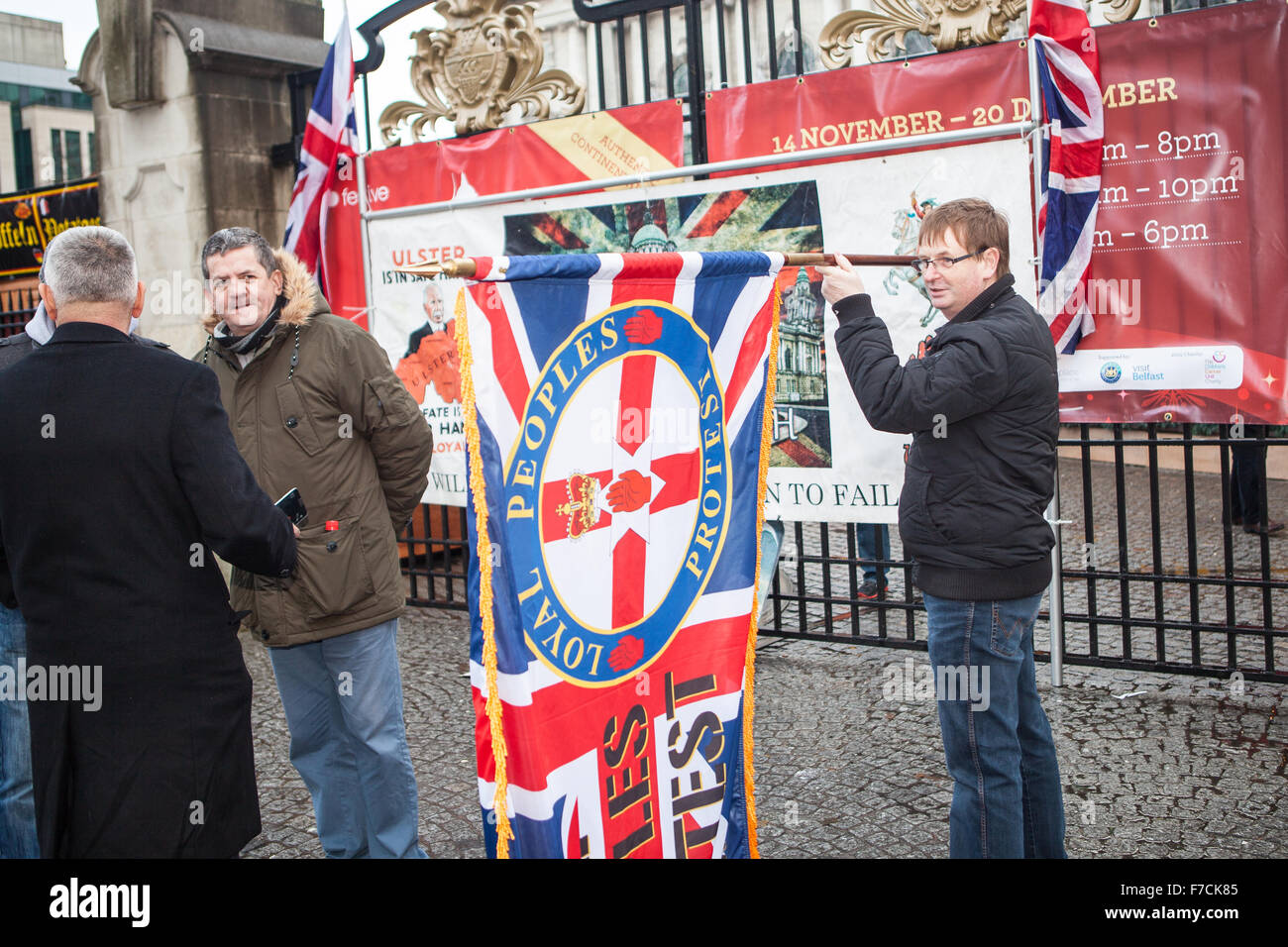 Belfast, UK. 28th November, 2015. Willie Frazer (R) Holding Loyal People Protest flag at the 3rd Anniversary decision of  Belfast City Council to restrict the flying of the union flag to 18 days per year. Mr Frazer is the founder and leader of the pressure group Families Acting for Innocent Relatives (FAIR). Credit:  Bonzo/Alamy Live News Stock Photo