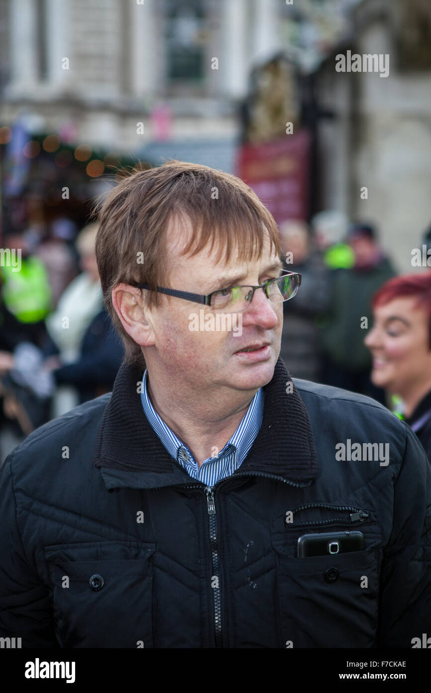 Belfast, UK. 28th November, 2015. Willie Frazer  founder and leader of the pressure group Families Acting for Innocent Relatives (FAIR). holding a Loyal People Protest flag at the 3rd Anniversary of Belfast City Council to restrict the flying of the union flag to 18 days per year Credit:  Bonzo/Alamy Live News Stock Photo
