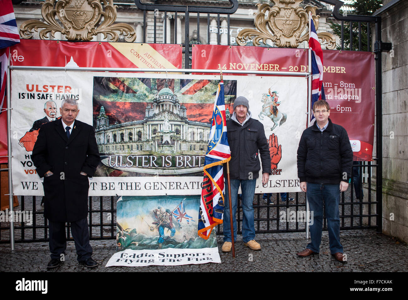 Belfast, UK. 28th November, 2015. Willie Frazer (R)  founder and leader of the pressure group Families Acting for Innocent Relatives (FAIR) with supporters. holding a Loyal People Protest flag at the 3rd Anniversary of Belfast City Council to restrict the flying of the union flag to 18 days per year Credit:  Bonzo/Alamy Live News Stock Photo