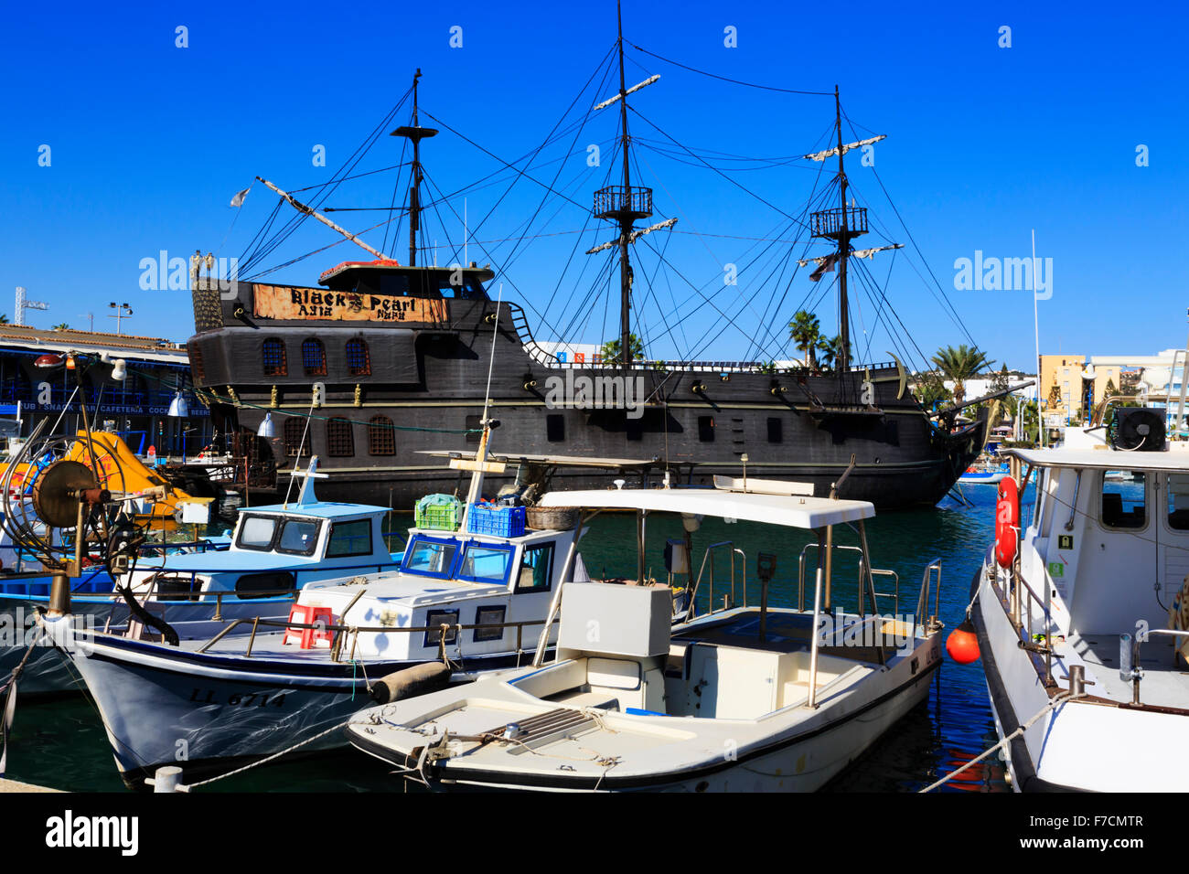 'Black Pearl' party boat in Ayia Napa harbour with local fishing boats. Ayia Napa harbour, Cyprus. Stock Photo