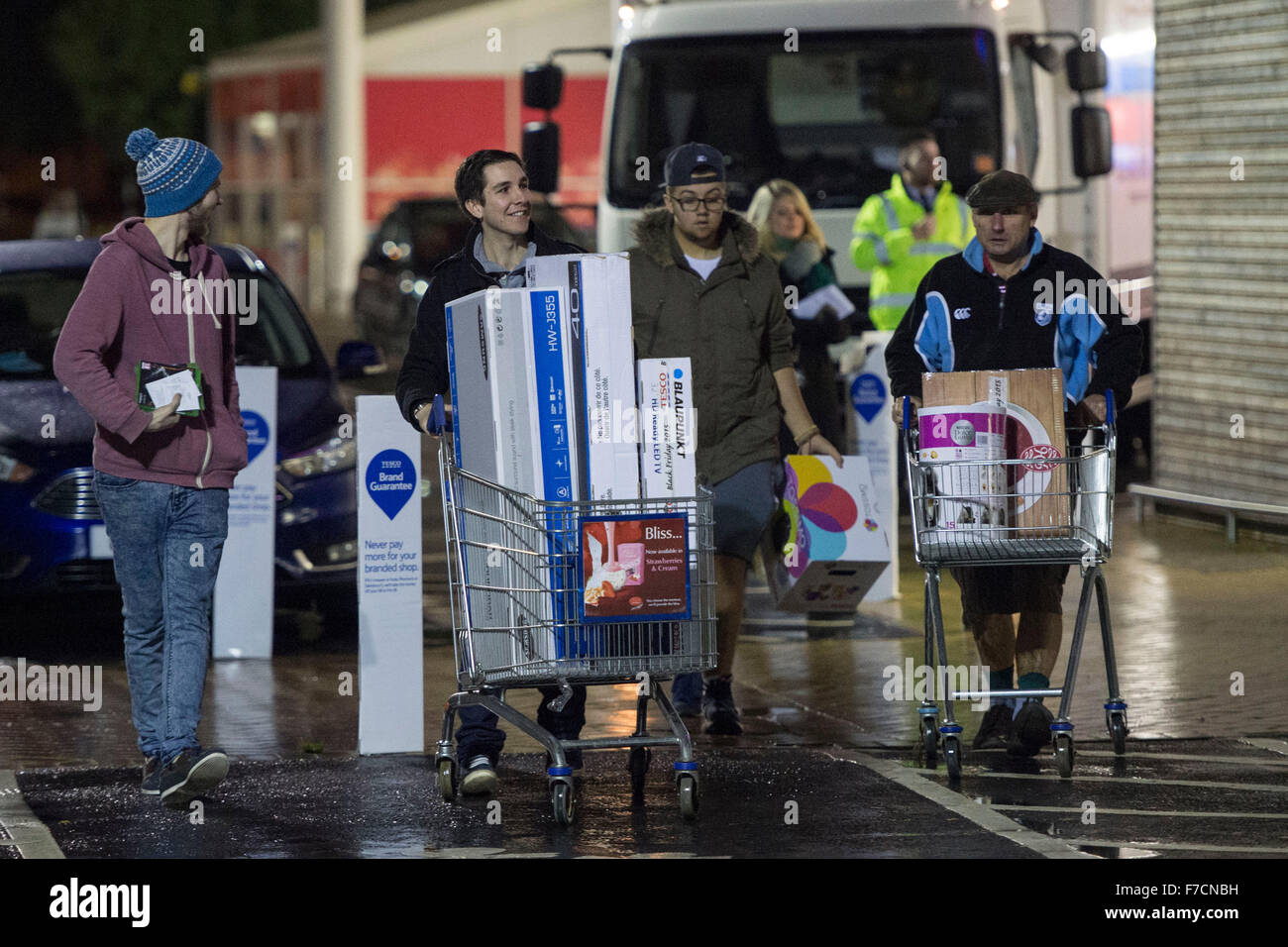 Shoppers queue for Black Friday sales at Tesco Extra supermarket on Western Avenue in Cardiff, South Wales. Stock Photo
