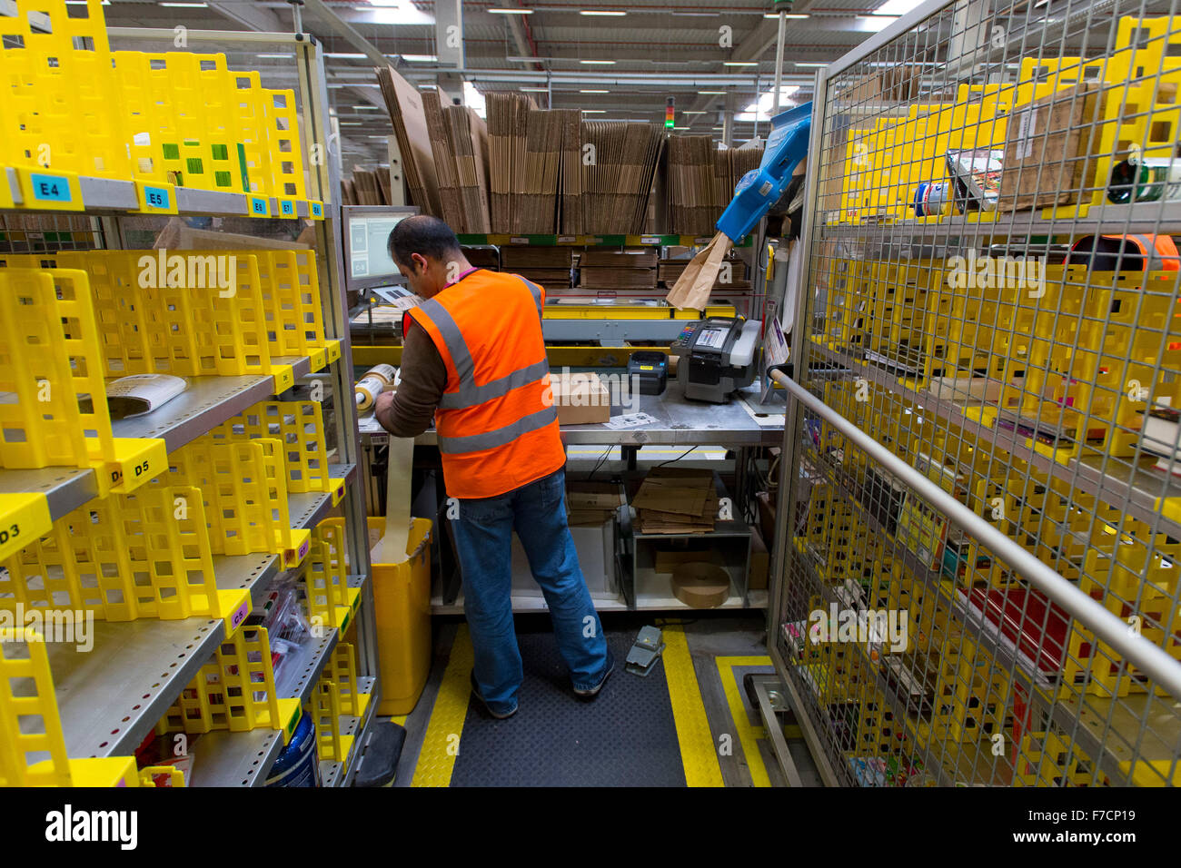 Stock pickers in the Amazon Fulfillment Centre warehouse in Swansea, Wales. Extra staff are hired on Cyber Monday & Black Friday Stock Photo