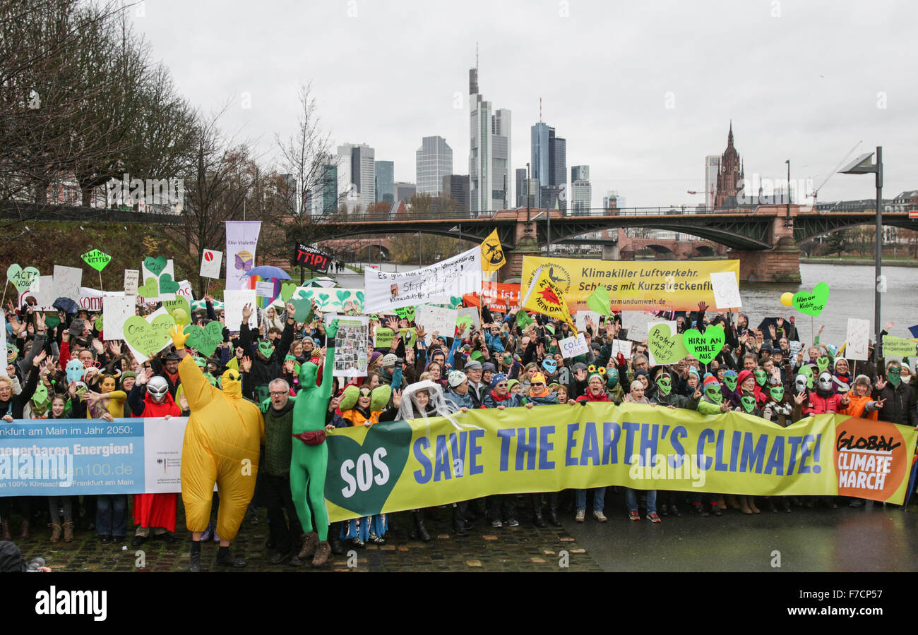 Frankfurt, Germany. 29th Nov, 2015. Climate activists hold up banners and signs during a rally on occasion of the United Nations Climate Change Conference in Paris, France, in front of the skyline of Frankfurt am Main, Germany, 29 November 2015. Credit:  dpa picture alliance/Alamy Live News Stock Photo