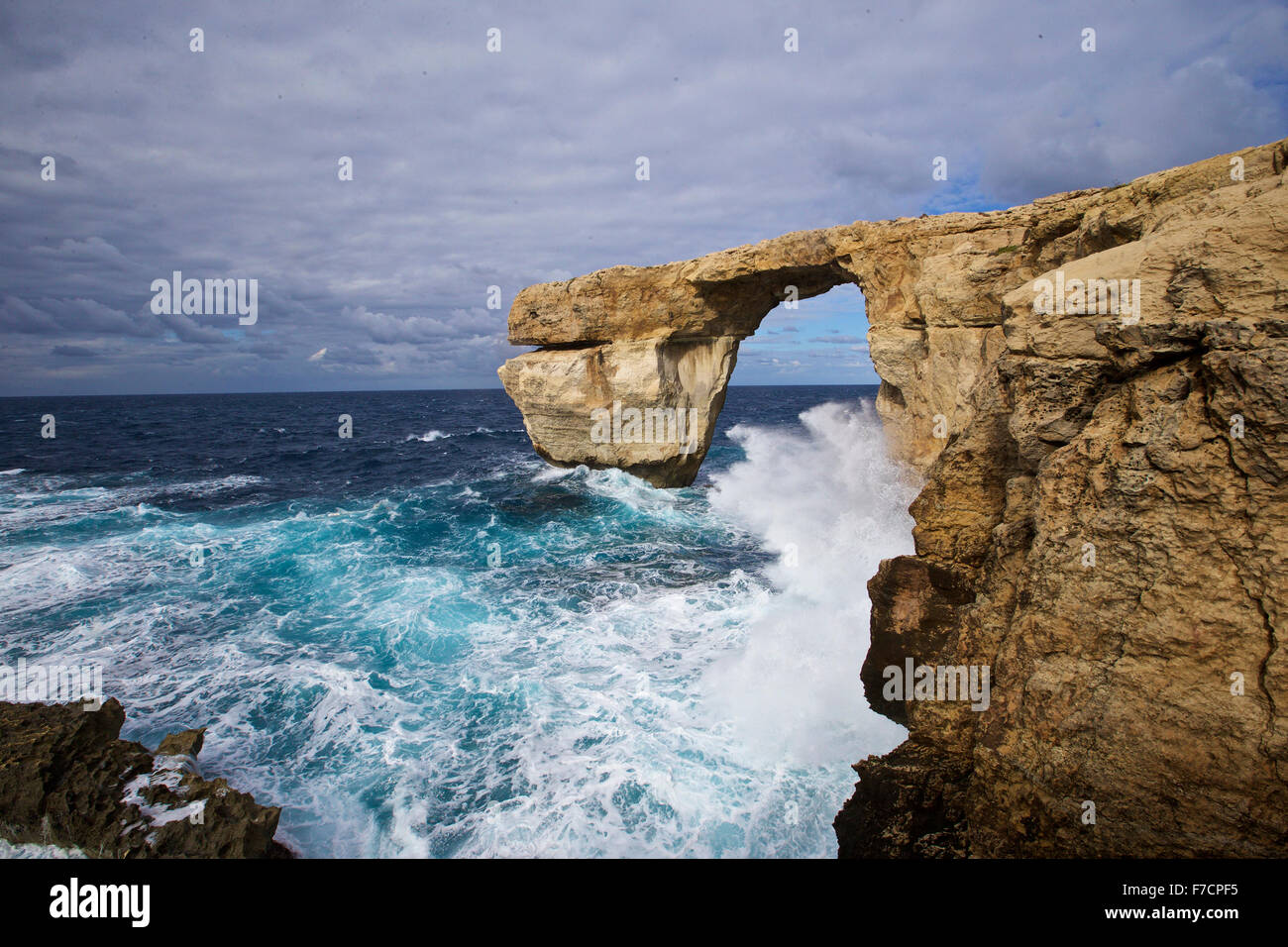 (151129) -- VALLETTA, Nov. 29, 2015 (Xinhua) -- Photo taken on Nov. 28, 2015, in Gozo, Malta shows the view of the Azure Window. The Azure Window, Malta's famous natural landscape, is located in its second largest island Gozo. The Azure Window is one of the most photographed vistas of Malta, and is particularly spectacular during the winter, when waves crash high inside the arch. At the end of the cliff, the Azure Window is a giant doorway, through which one can admire the water expanse beyond the cliff. The sea around is very deep and of a dark blue hue, which explains why it is called the Az Stock Photo