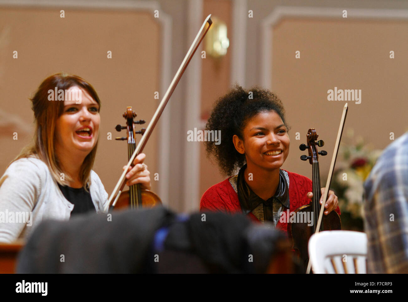 two young violinists laughing in rehearsals Stock Photo