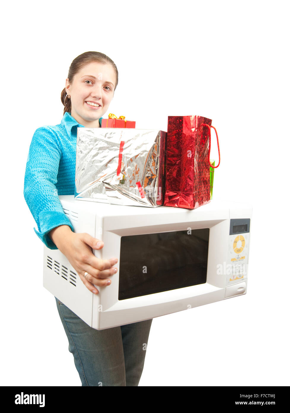 Girl with microwave oven and present boxes. Isolated over white Stock Photo