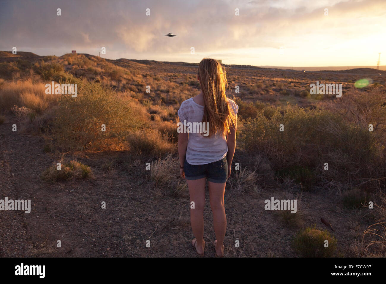Girl watches a UFO in the New Mexico desert, USA. Stock Photo
