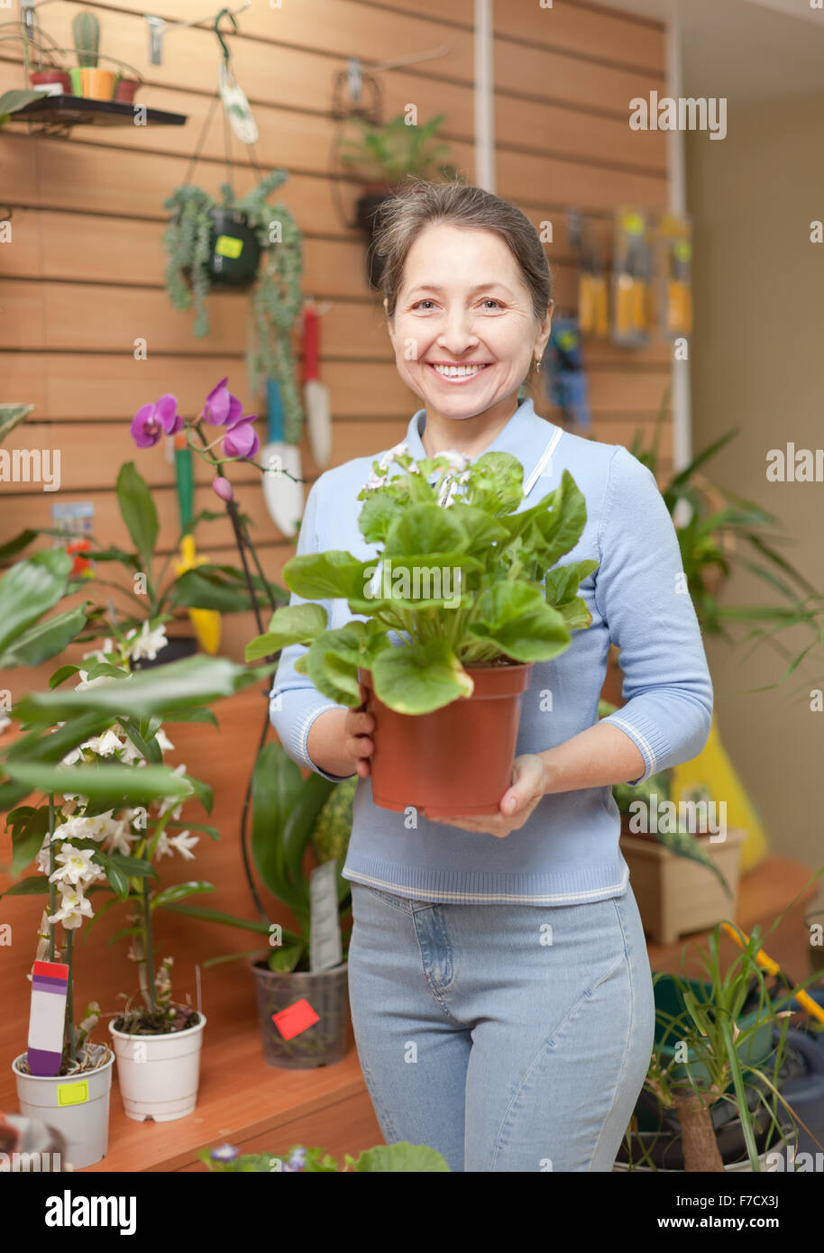 Happy mature woman in floral store Stock Photo
