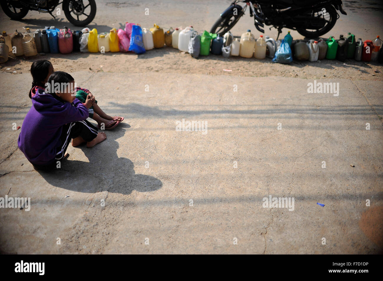 Kathmandu, Nepal. 29th Nov, 2015. Nepalese Children stays on a queue of Kerosene from early morning to get 2ltrs of Kerosene at Kirtipur, Kathmandu, Nepal on 29 November, 2015. As from the past few months neighboring India had Blockade the Border; which transport fuel and daily commodities to Nepal; results shortage of fuel and daily commodities in Nepal. © Narayan Maharjan/Pacific Press/Alamy Live News Stock Photo