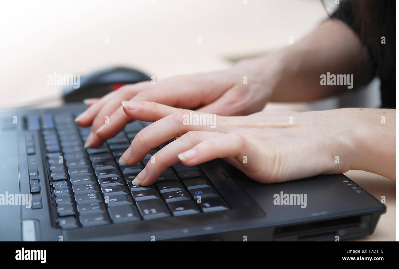 woman hands typing on laptop keyboard Stock Photo