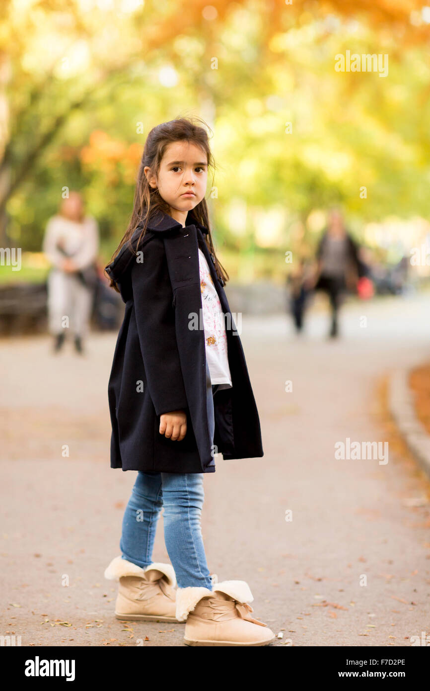 Little girl in the autumn park Stock Photo - Alamy
