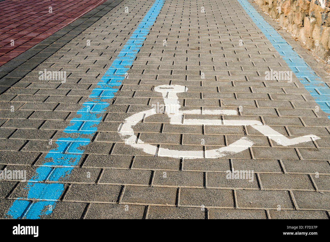 Brick footpath path pavement marked with lane area for disabled people in wheelchair wheelchairs Stock Photo