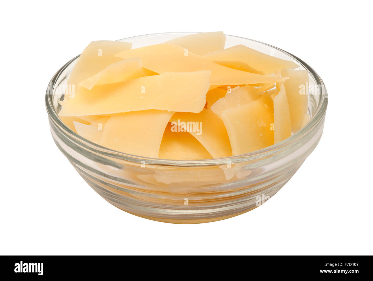 Shaved Parmesan Cheese in a glass bowl. The image is a cut out, isolated on a white background, Stock Photo