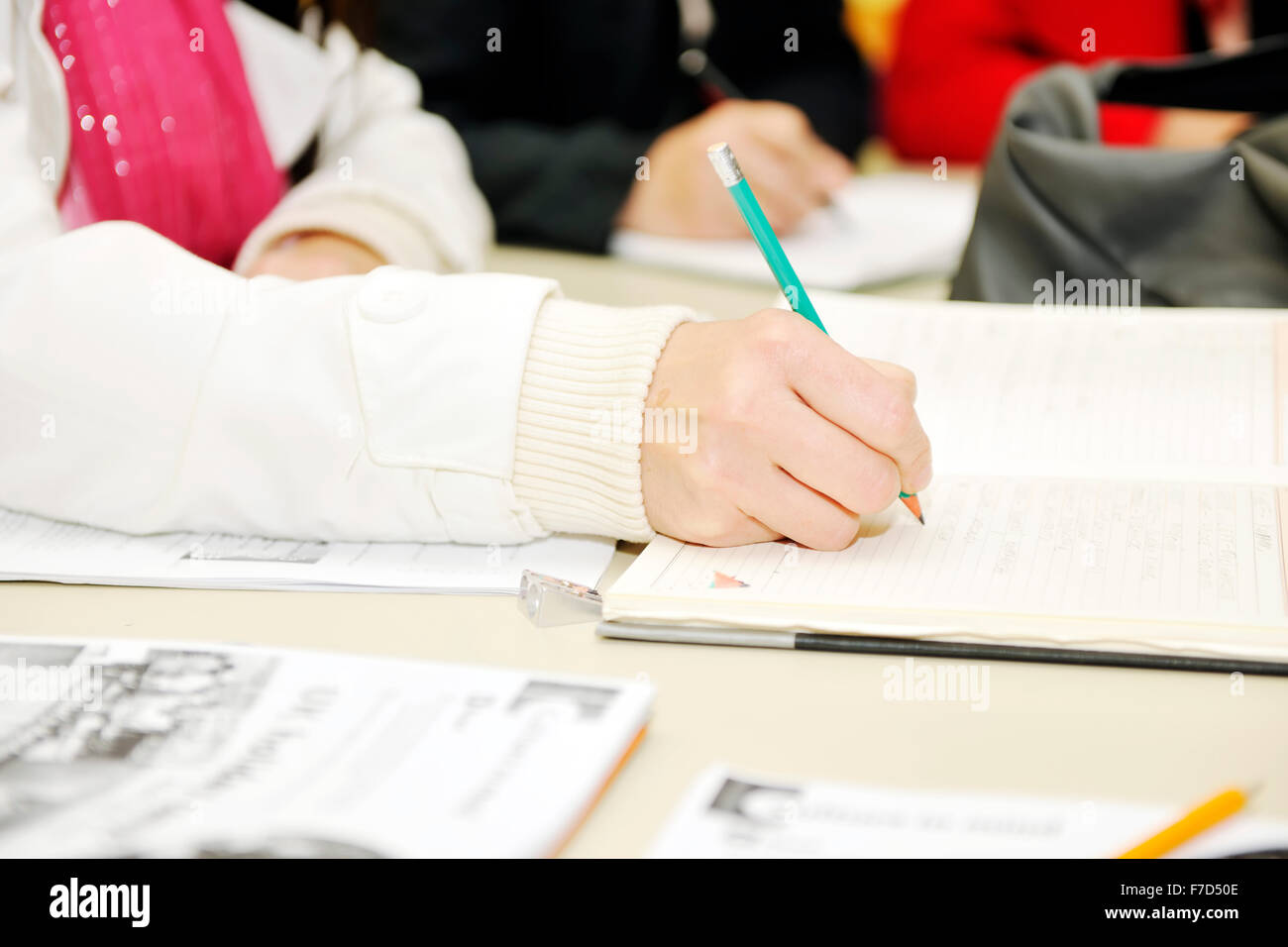 education concept with students who taking notes and learning lessons ...