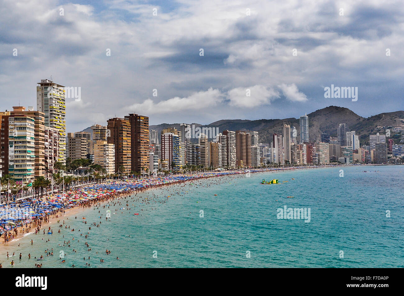 Crowded beach of Benidorm on a cloudy day, Spain Stock Photo