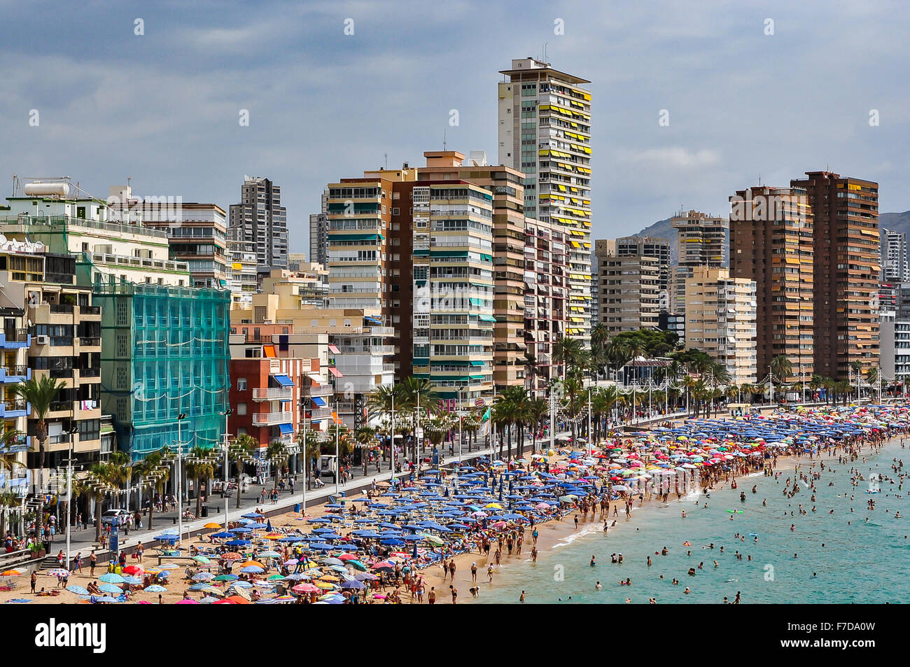 Crowded beach of Benidorm on a cloudy day, Spain Stock Photo