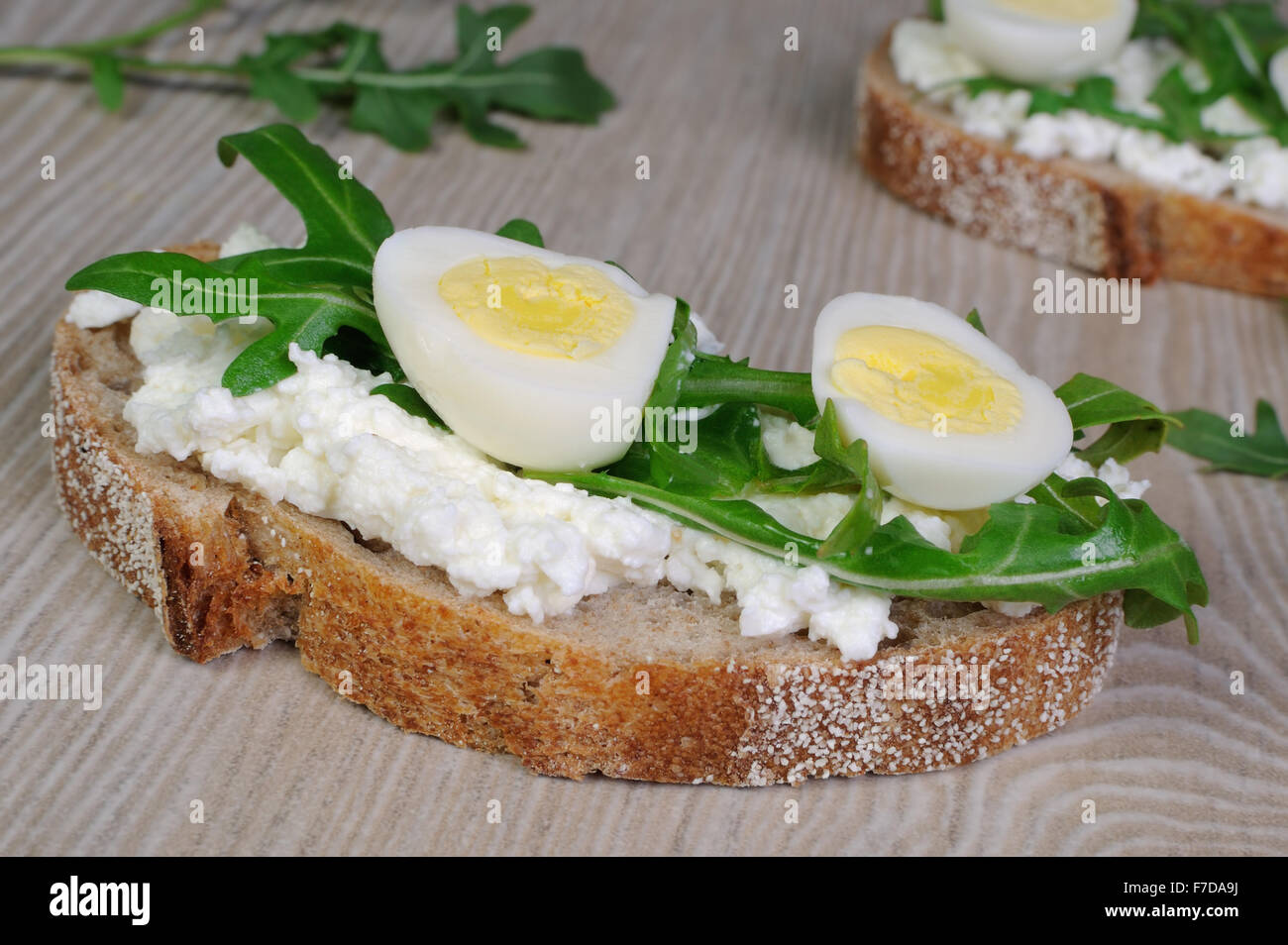 Sandwich with arugula and quail egg with leaves of arugula Stock Photo