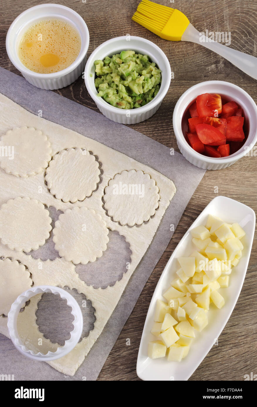Ingredients for baking bun of puff pastry with cheese, tomato, avocado Stock Photo
