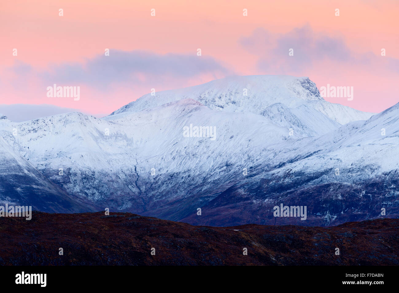 A snow-capped Stob Choire a' Chairn and Ben Nevis (behind) just before sunrise, Scotland Stock Photo