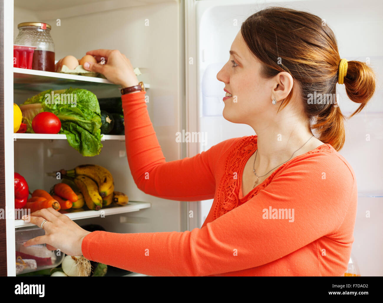 Young housewife near refrigerator  at home Stock Photo