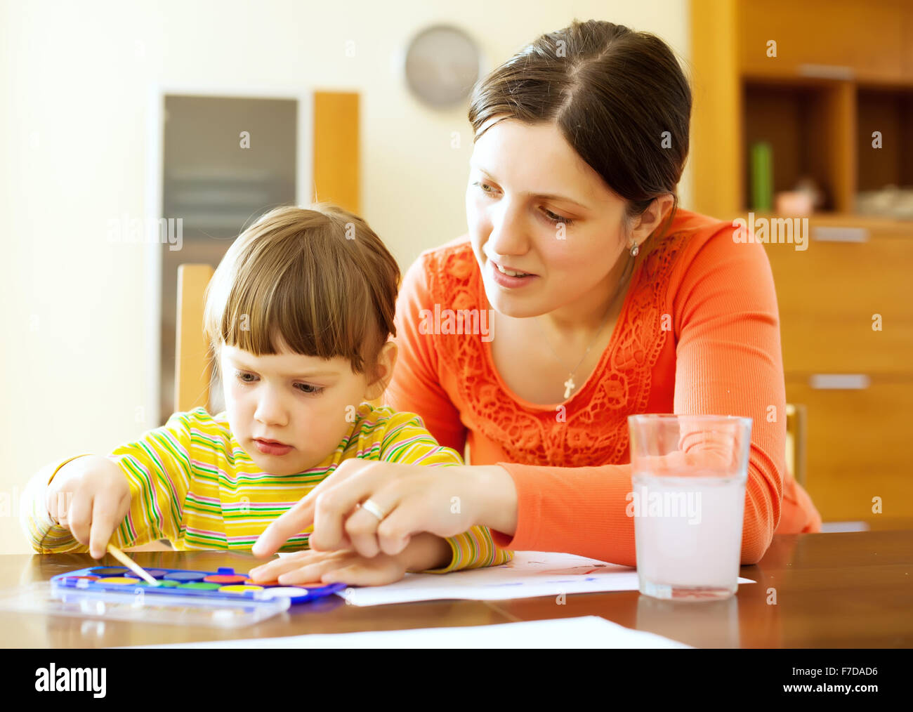 Happy mother and baby painting on paper with watercolor Stock Photo - Alamy
