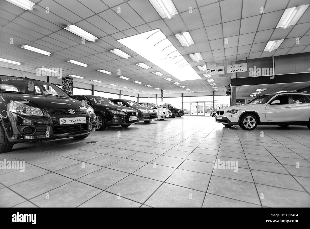 Used cars in a showroom photograph in black and white Stock Photo