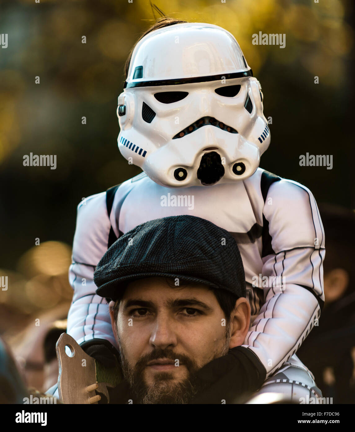 Barcelona, Spain. 29th November, 2015. A boy taking part in the 9th Star Wars parade in front of Barcelona's Arc de Triomf on the shoulders of his father is dressed up as the 'Stromtrooper' movie characters Credit:  matthi/Alamy Live News Stock Photo