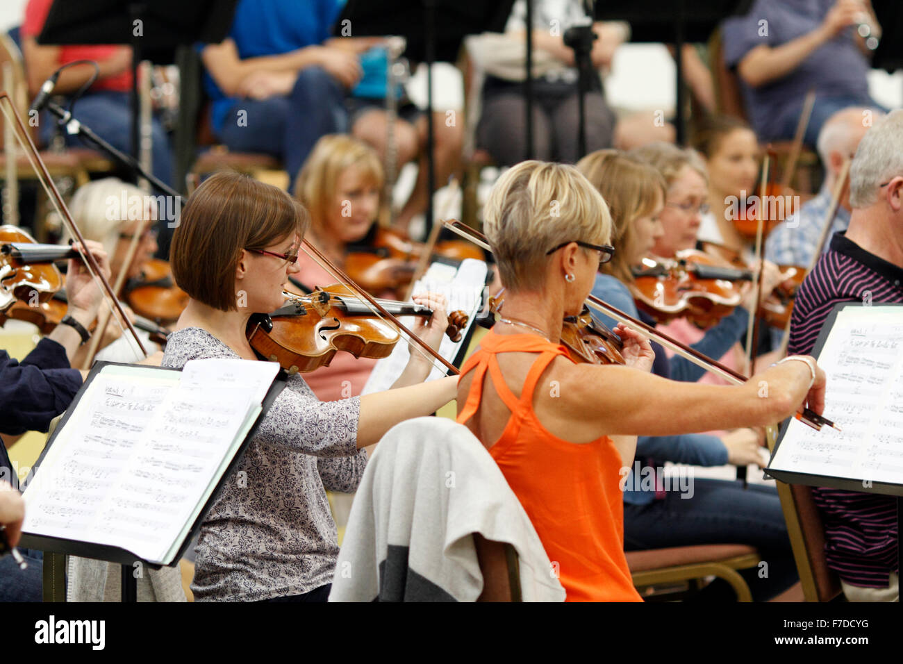 Violin players in an orchestral rehearsal Stock Photo