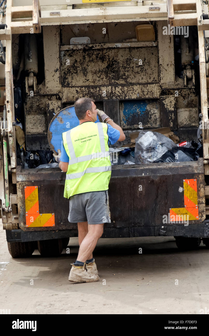 A Waste Collector at The Great Dorset Steam Fair empties rubbish from a