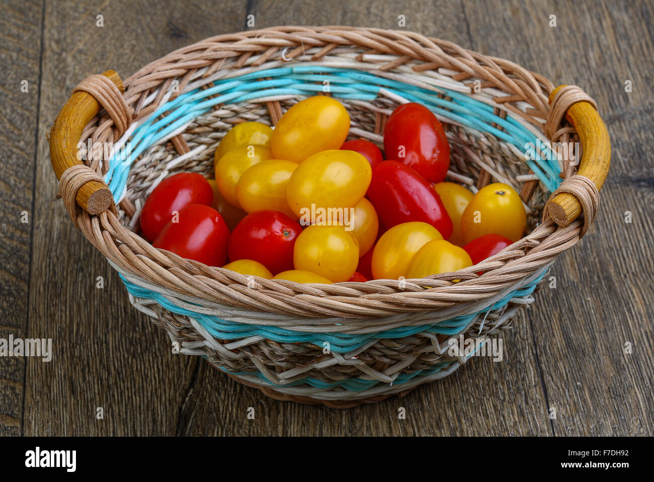 Yellow and red cherry tomatoes mix on the basket Stock Photo - Alamy