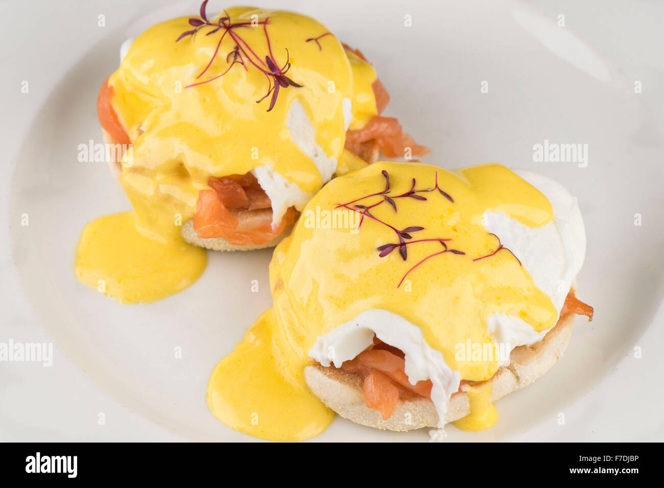 Eggs Royale breakfast consisting of an English muffin, smoked salmon and eggs with hollandaise sauce served on a white plate Stock Photo