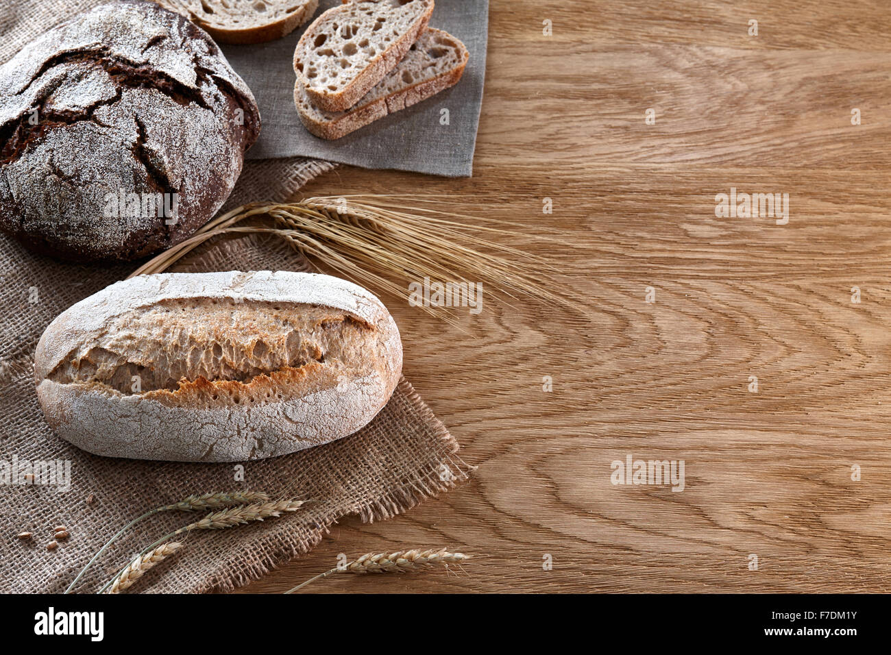 Assortment of baked bread on wooden background Stock Photo