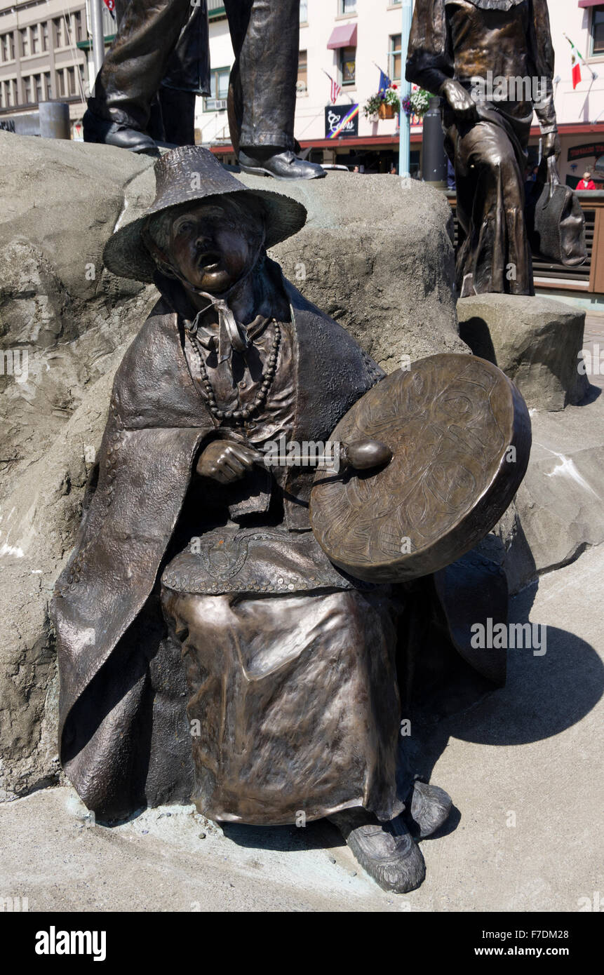 Dave Rubin's bronze monument 'The Rock', 2010.  Tlingit woman sits with drum singing. Stock Photo