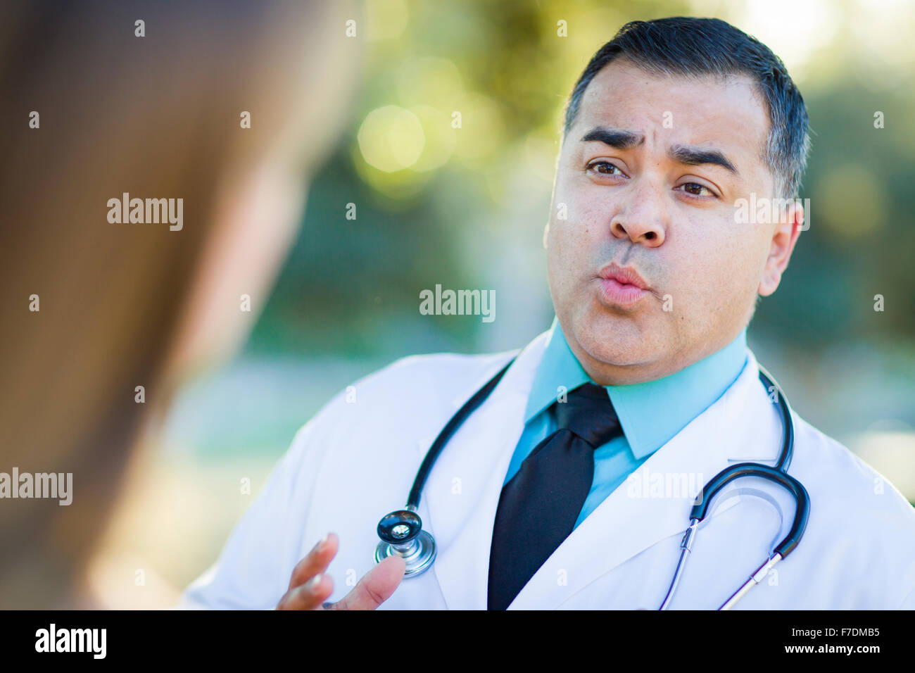 Hispanic man speaking to doctor hi-res stock photography and images - Alamy