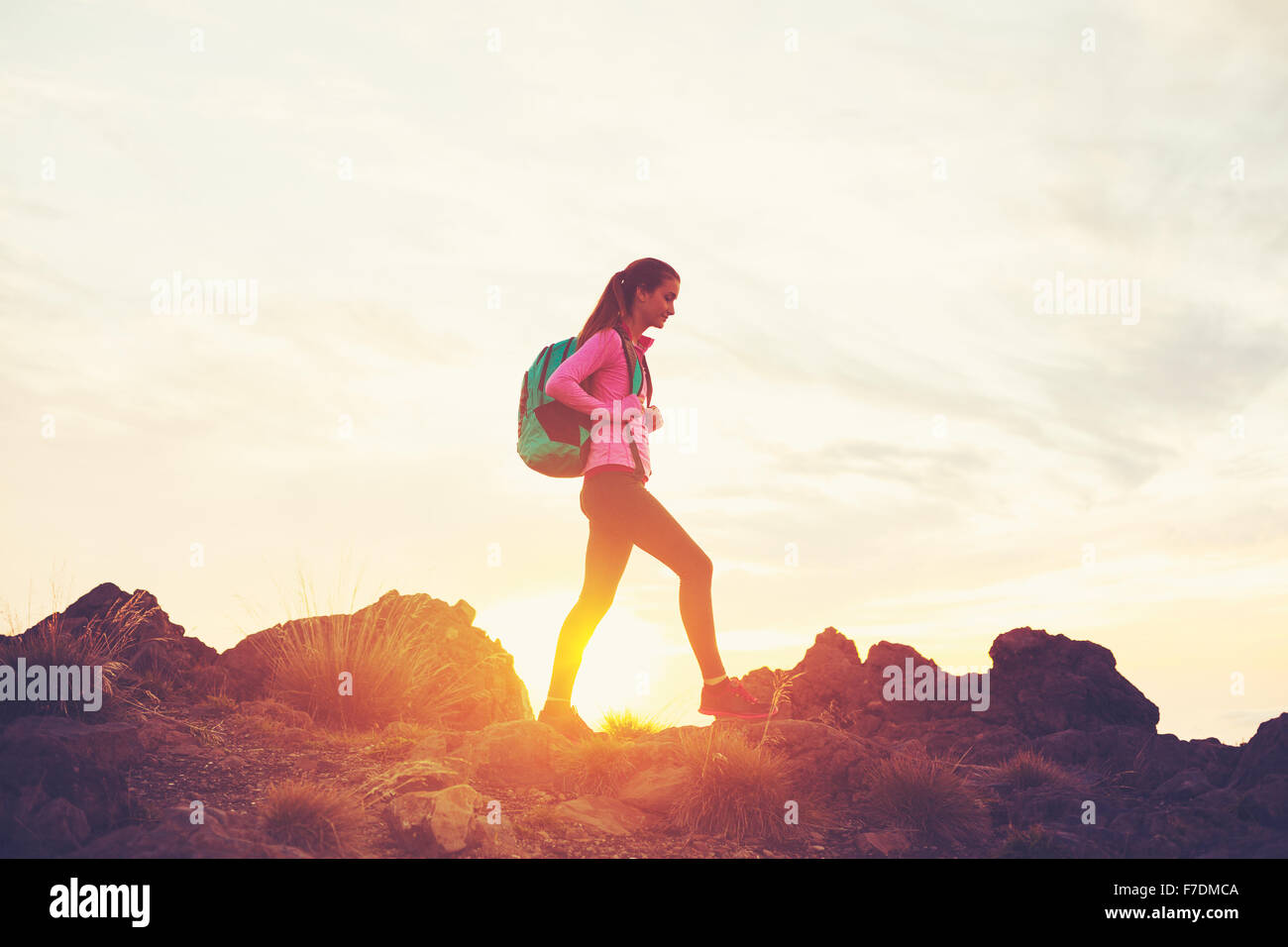 Woman Hiking in the Mountains at Sunset, Adventure Outdoor Active Lifestyle Stock Photo