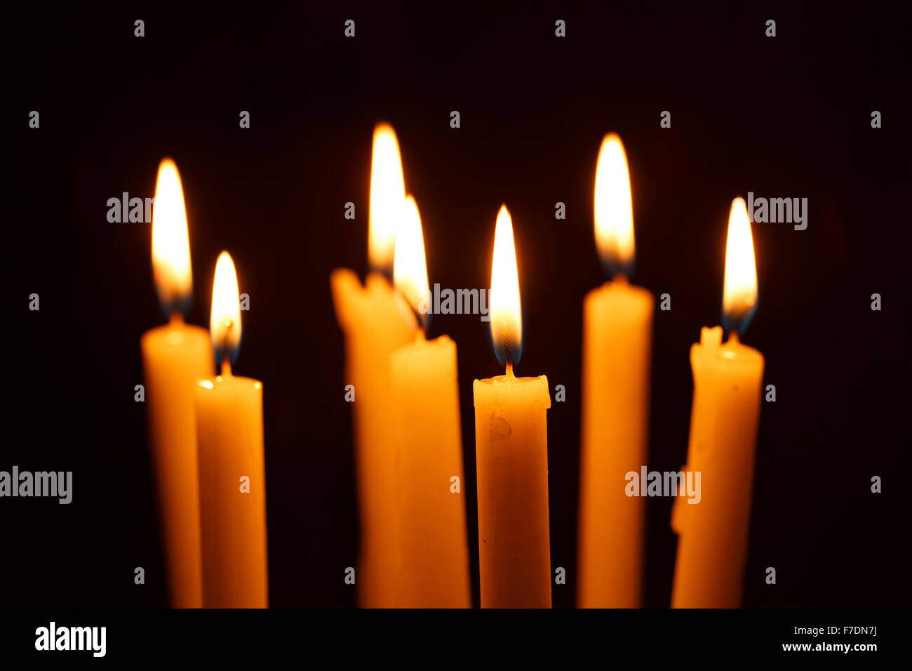 Many burning candles on black background Stock Photo - Alamy