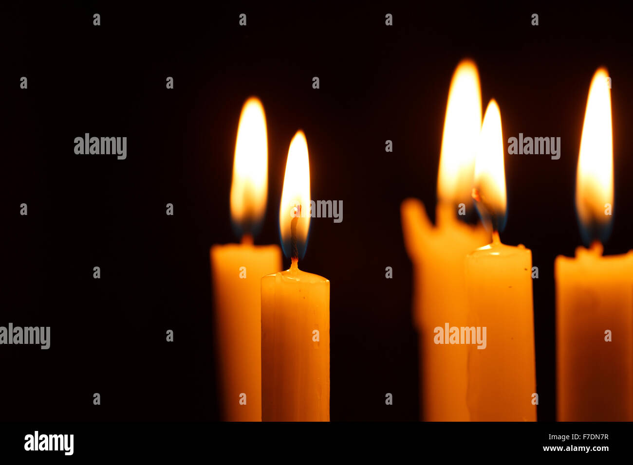 Many burning candles on black background Stock Photo - Alamy