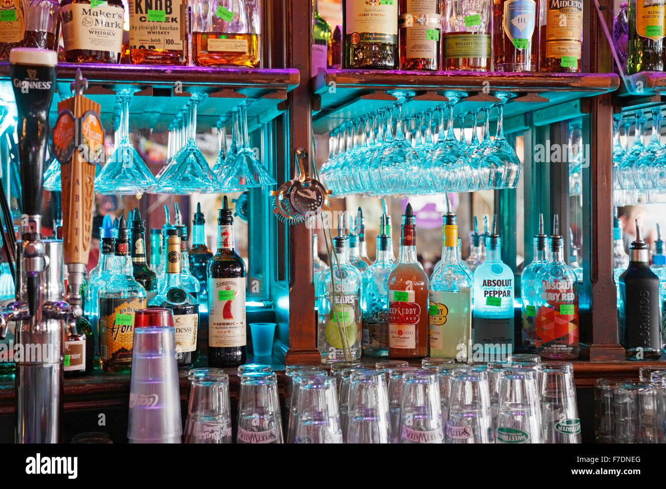 Alcohol and liquor bottles lined up in a bar and pub Stock Photo