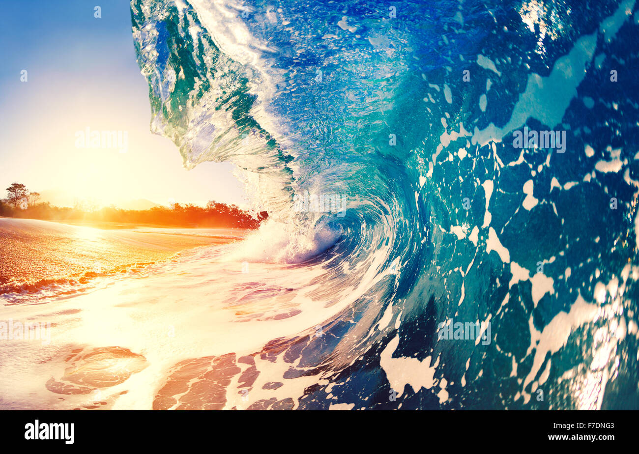 Blue Ocean Wave Crashing at Sunrise Stock Photo