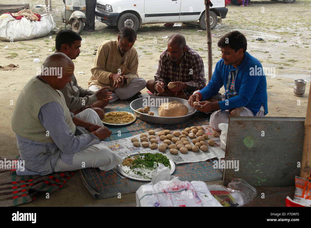 Allahabad, India. 29th Nov, 2015. Hindu devotees preparing Bati (roti ...