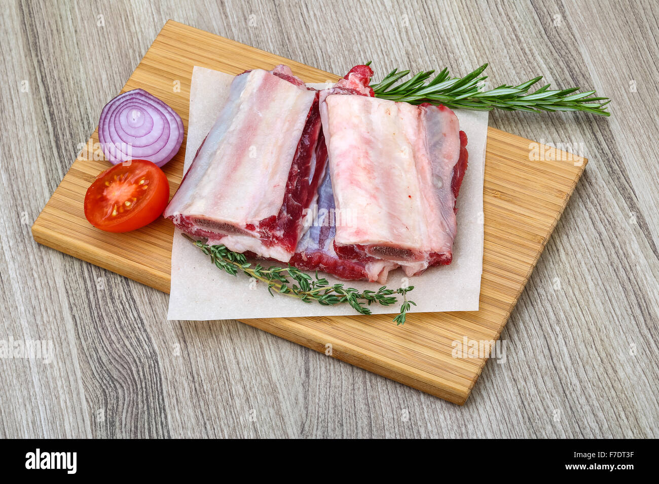 Raw beef ribs with rosemary and thyme ready for cooking Stock Photo