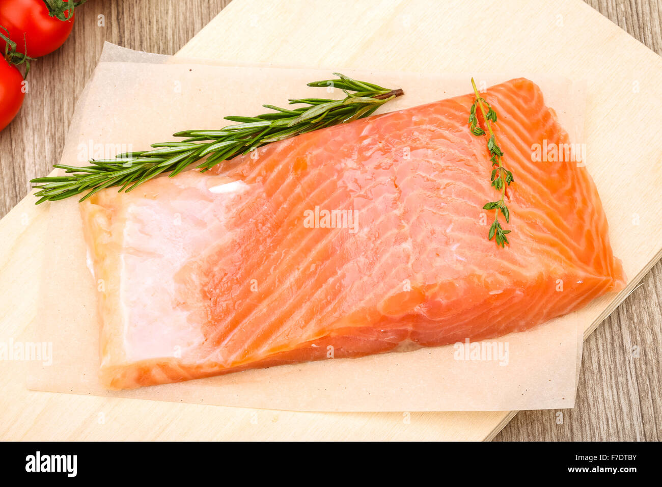 Salted salmon with rosemary and thyme on the wood background Stock