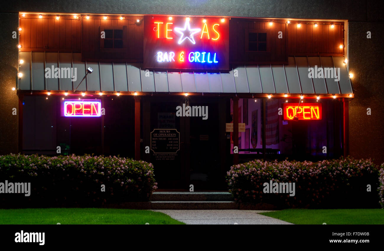 Texas bar and grill with two open signs Stock Photo - Alamy