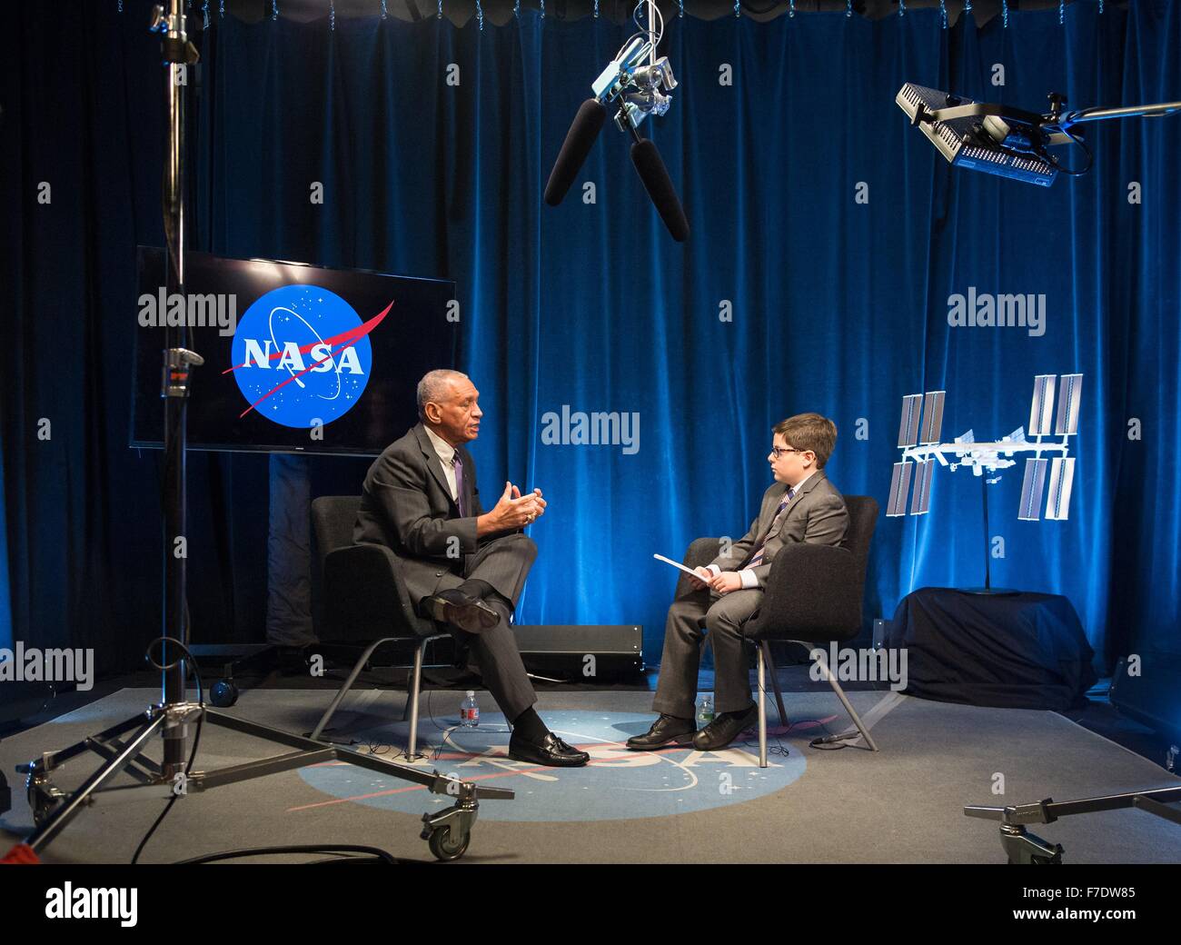 NASA Administrator Charles Bolden is interviewed by nine-year old Max from Humans of New York at NASA Headquarters November 23, 2015 in Washington, DC. Max was featured on the HONY Facebook page on Nov. 14 stating he'd like to be a reporter like his dad, 'I'd start by going to the Director of NASA. Then I'd ask him about his rockets. And if any of them were going to space. Stock Photo
