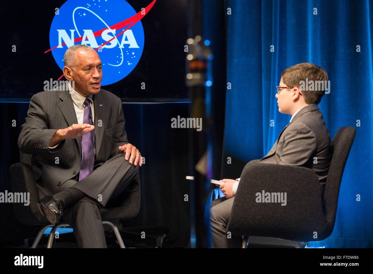 NASA Administrator Charles Bolden is interviewed by nine-year old Max from Humans of New York at NASA Headquarters November 23, 2015 in Washington, DC. Max was featured on the HONY Facebook page on Nov. 14 stating he'd like to be a reporter like his dad, 'I'd start by going to the Director of NASA. Then I'd ask him about his rockets. And if any of them were going to space. Stock Photo