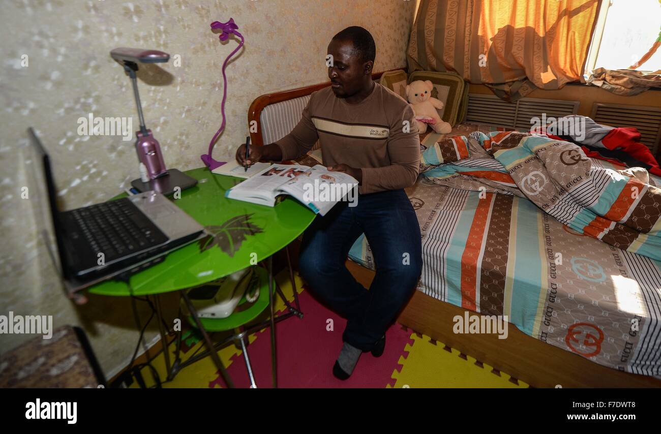 Changchun, China's Jilin Province. 27th Nov, 2015. Ramazani Nashiri, a medical student from Burundi, writes notes at his dorm room in Changchun, capital of northeast China's Jilin Province, Nov. 27, 2015. Nashiri, 40, has lived in China for nine years to study gynecology and obstetrics. He now is a PhD student at the Norman Bethune Health Science Center of Jilin University. A total of 528 foreign students studied medicine at the center, most of whom come from Asia and African nations. © Wang Haofei/Xinhua/Alamy Live News Stock Photo