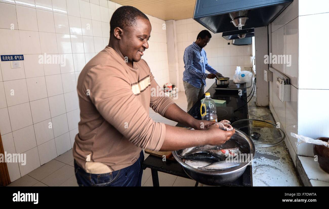 Changchun, China's Jilin Province. 27th Nov, 2015. Ramazani Nashiri (L), a medical student from Burundi, makes traditional Burundian food at his dorm room in Changchun, capital of northeast China's Jilin Province, Nov. 27, 2015. Nashiri, 40, has lived in China for nine years to study gynecology and obstetrics. He now is a PhD student at the Norman Bethune Health Science Center of Jilin University. A total of 528 foreign students studied medicine at the center, most of whom come from Asia and African nations. © Wang Haofei/Xinhua/Alamy Live News Stock Photo