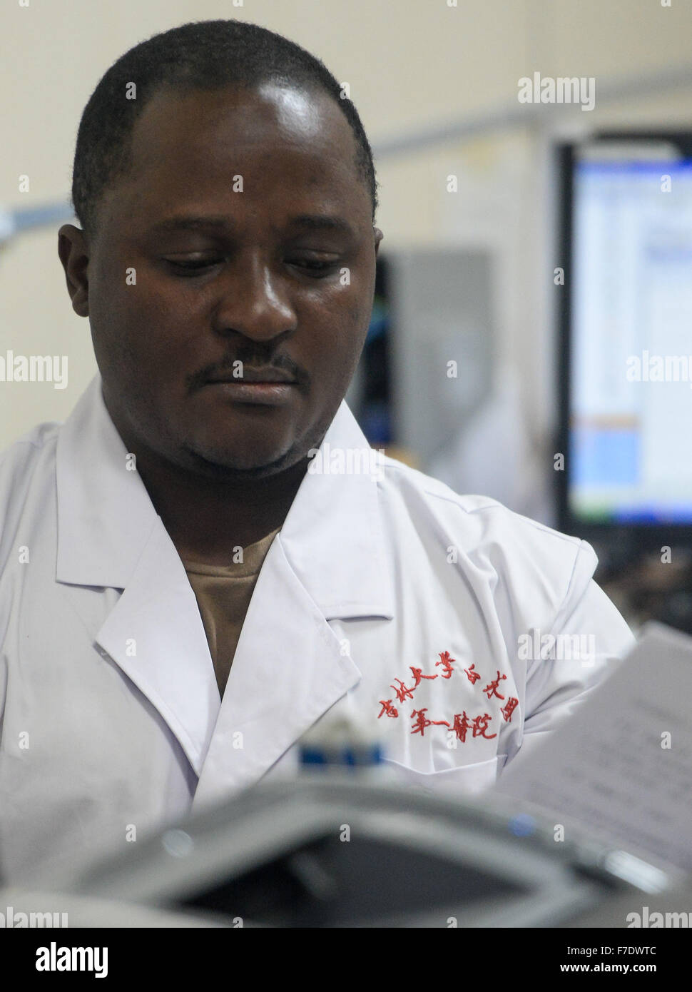 Changchun, China's Jilin Province. 27th Nov, 2015. Ramazani Nashiri, a medical student from Burundi, reviews patients' medical records at the First Hospital of Jilin University in Changchun, capital of northeast China's Jilin Province, Nov. 27, 2015. Nashiri, 40, has lived in China for nine years to study gynecology and obstetrics. He now is a PhD student at the Norman Bethune Health Science Center of Jilin University. A total of 528 foreign students studied medicine at the center, most of whom come from Asia and African nations. © Wang Haofei/Xinhua/Alamy Live News Stock Photo